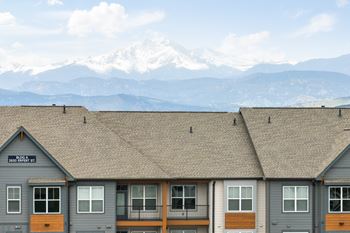 the roof of a building with mountains in the background